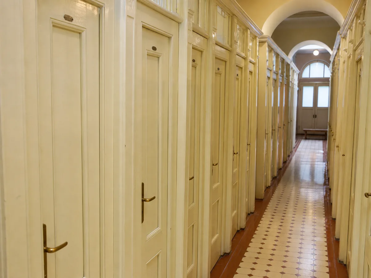 A corridor of wooden private changing cabins